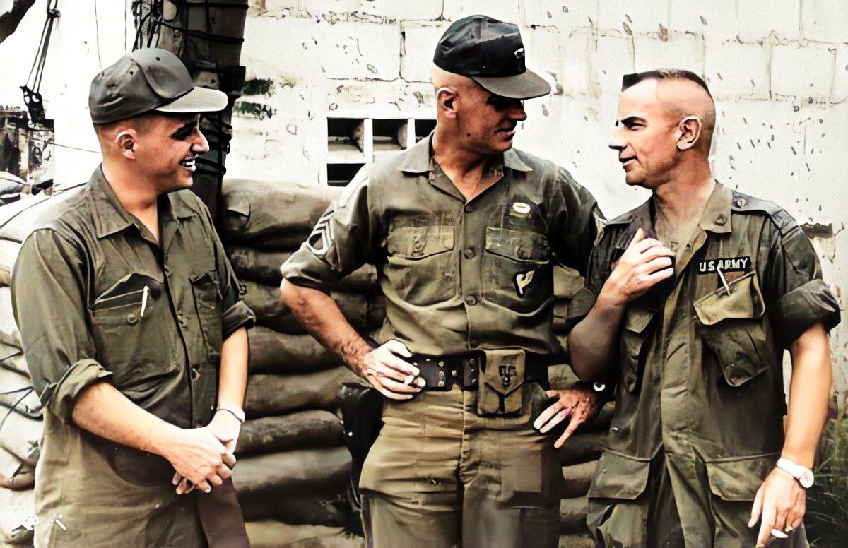 Charles Moskos standing with 2 other soldiers